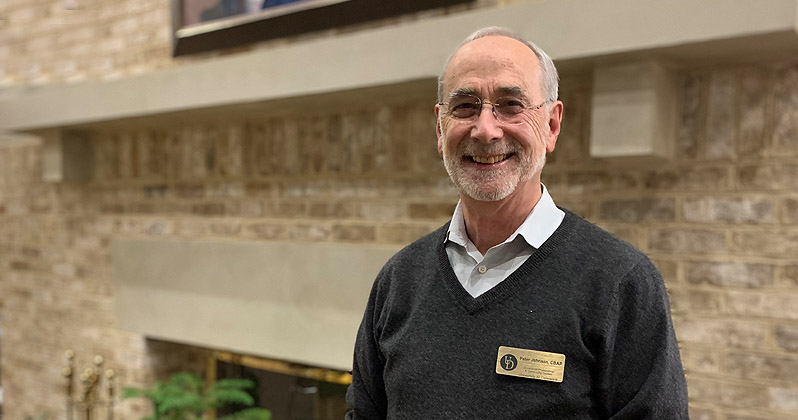 Instructor Peter Johnson smiling in Arsht Hall lobby
