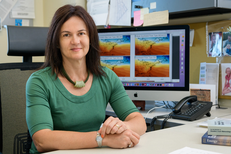 Environmental portrait of Christina Archer, a professor in the School of Marine Science and Policy in the College of Earth, Ocean, and Environment, in and near her Interdisciplinary Science and Engineering Lab office. Photographed to accompany a UDaily article about a recent study she published with 2 co-authors on how “[g]lobal warming will aggravate ozone pollution in the US Mid-Atlantic” [Paper title].