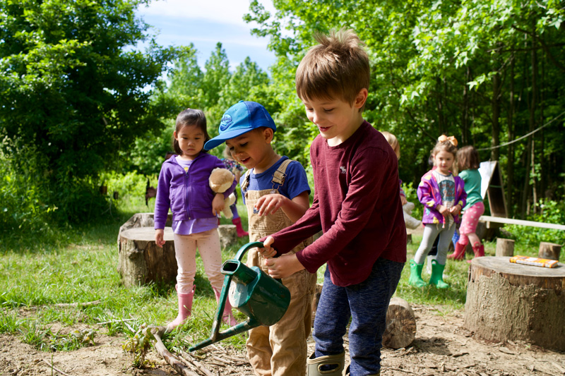 Children watering the edible flower garden at the UD Early Childhood Center. Photos by Eric Rush. Photo releases obtained by Eric Rush.