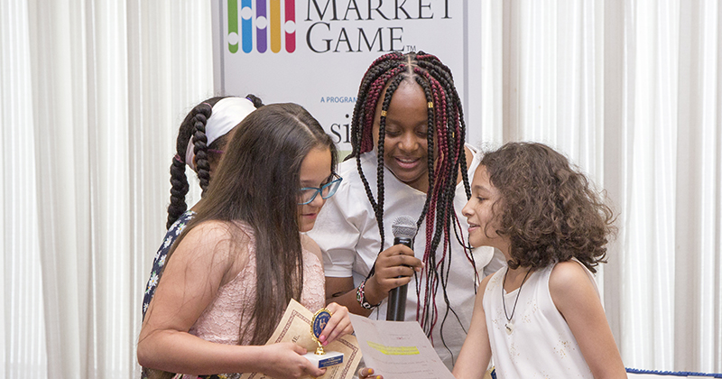 UD’s Alfred Lerner College of Business and Economics sponsors the Stock Market Game for elementary, middle and high school students in Delaware. Pictured above is the fourth through sixth grade division accepting their award.