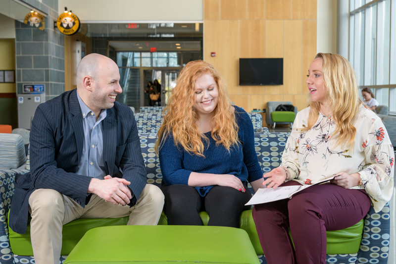 Assistant professor in the School of Education Josh Wilson (jacket) with two students, McKenna Winnie (blue sweater) and Ally Raiche (white floral blouse) for use by the College of Education and Human Development in promotional and editorial use. - (Evan Krape / University of Delaware)