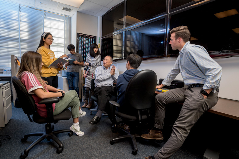 Professor Xiao-Hai Yan works on climate change with the help of his students James Simkins (blue/white striped shirt), Lina Wang (yellow sweatshirt), Lingsheng Meng (gray t-shirt), Anglea Ditri (pink Addias shirt), Hashei Sun (blue sweatshirt), Nan Chen (navy blue/white striped dress). (Releases were obtained on all involved.)