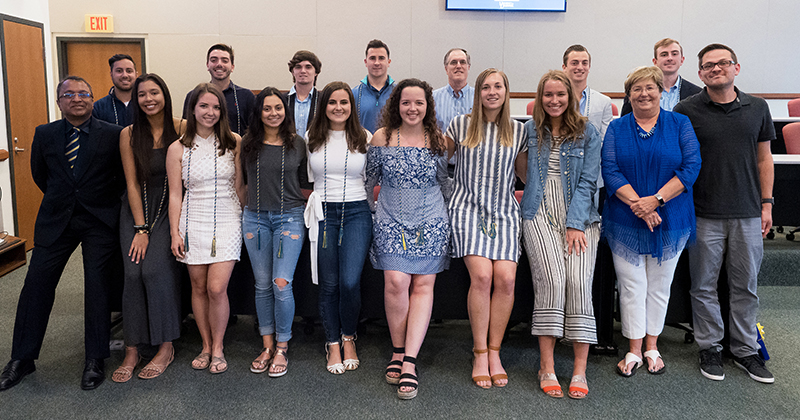 Students and faculty of the minor in professional selling and sales management pose together.