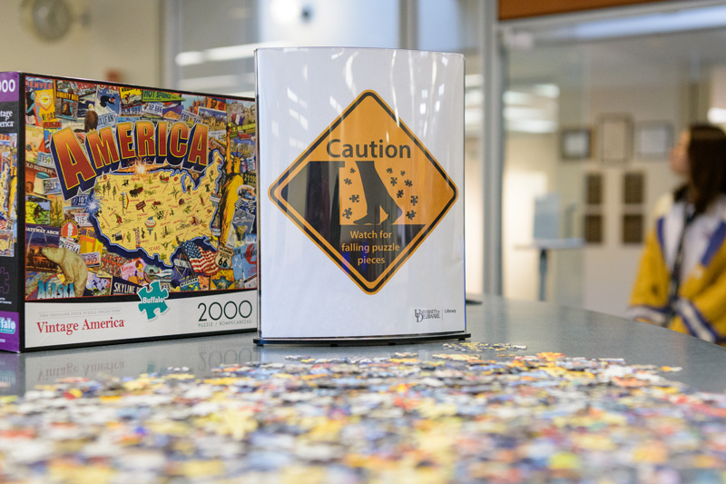 Puzzles at Morris Library at the Periodicals and Reference desk for students to put together when they need a break from their studying for finals. Photographed for a UDaily article about “de-stressing” during finals week. - (Evan Krape / University of Delaware)