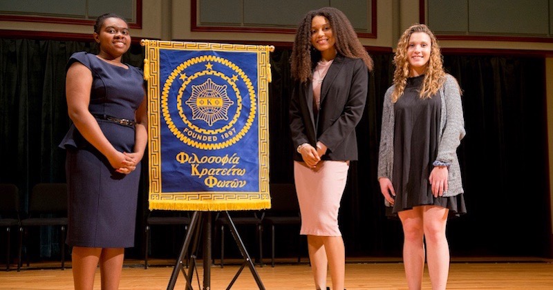 Three students on stage