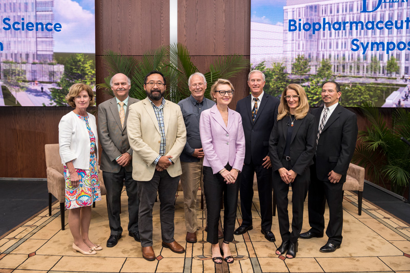 The Biopharmaceutical Science Symposium held on September 19th, 2019 features speakers and industry leaders in the pharmaceutical industry.  A group photo at the end involves all the speakers EXCEPT Michael Naso. 