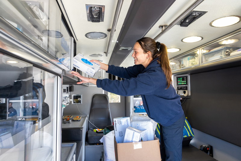 Elizabeth deBruin, EMT, of Newark’s Aetna Hose, Hook and Ladder Co. restocking her ambulance with medical supplies that were donated by the University of Delaware to help protect emergency responders during the COVID-19 pandemic.