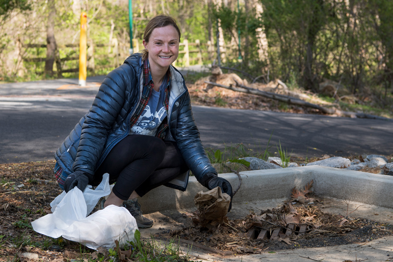 Clare Bondi ’20 (rust sweater), Jennifer Yarin ’20 (blue puffy jacket, blonde hair) and Lily Wolf ’20 (black puffy jacket, ponytail) are part of group called the Outing Club that does outdoor activities such as camping and hiking.  Today they are doing a clean-up as part of Earth Day. 