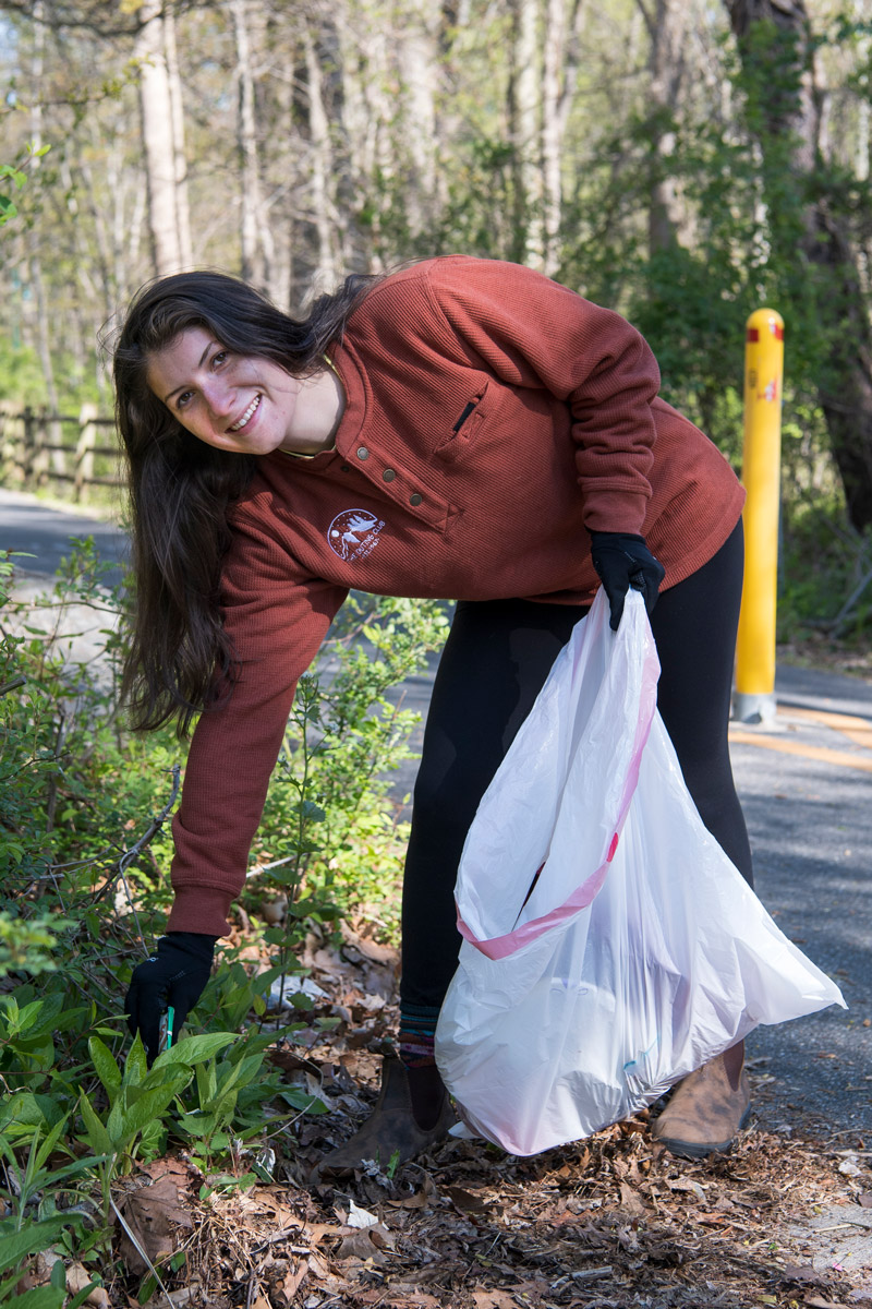 Clare Bondi ’20 (rust sweater), Jennifer Yarin ’20 (blue puffy jacket, blonde hair) and Lily Wolf ’20 (black puffy jacket, ponytail) are part of group called the Outing Club that does outdoor activities such as camping and hiking.  Today they are doing a clean-up as part of Earth Day. 