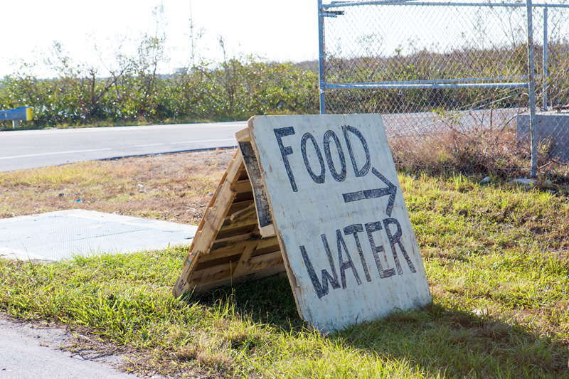 A sign has been put up on a street telling residents where to get food and water in the aftermath of a devastating hurricane. shot taken with Canon 5D Mark lV.