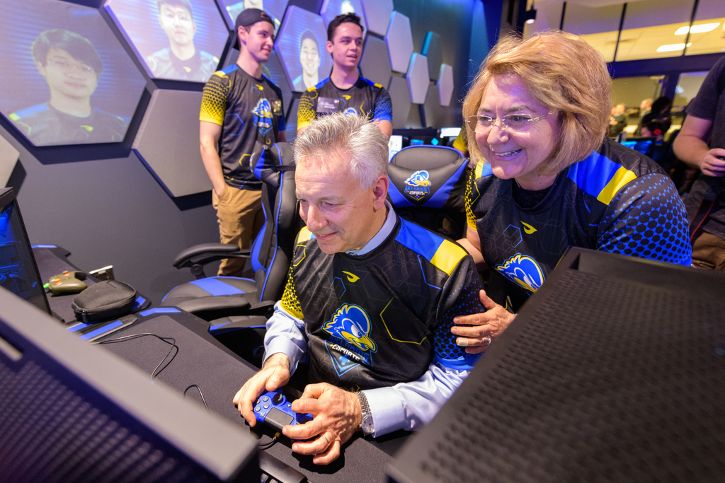 A leader in Esports: A state-of-the-art new Esports arena opened in February in UD's Perkins Student Center. Here, UD President Dennis Assanis and wife Eleni are trying out a game on one of the new gaming stations. 