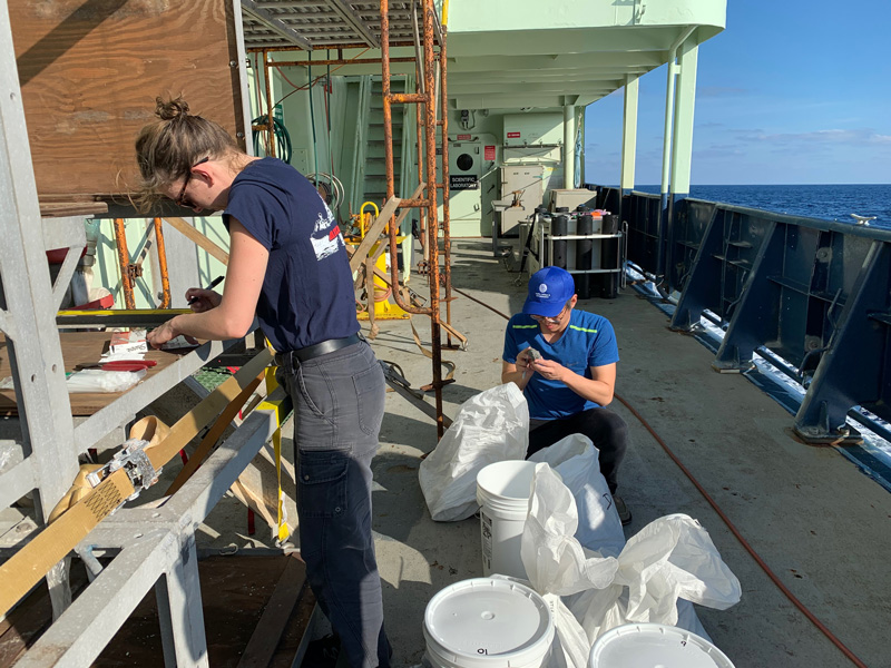 Cecile and Kuan-Yu sorting rocks on deck Cecile and Kuan-Yu sorting rocks on deck