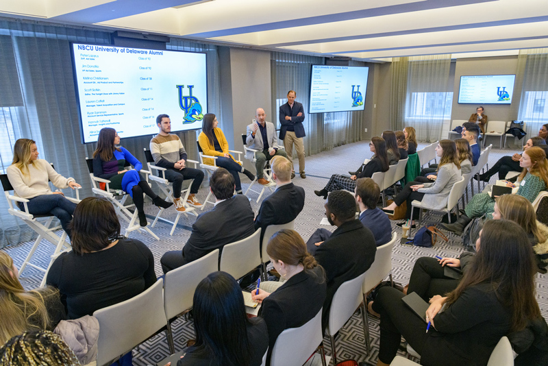 Students on a Communications sponsored and organized "Career Trek" to New York City had the opportunity to visit 30 Rockefeller Plaza -  the headquarters of NBC, the New York facilities of NBC Studios, and NBCUniversal Cable. While there students had the opportunity to talk to a panel of UD alumni who work for NBCUniversal.

Panelist (from left): Alina Serbina, Account Service Representative, Bravo/Oxy (Class of '17 - white sweater); Kristina Christiansen, Accounting Dir,. Ad Product and Partnerships (Class of '08 - black, purple, blue outfit); Scott Slotkin, Editor, The Tonight Show with Jimmy Fallon (Class of '11 - brown, white, and black sweater); Hannah Tattersall, Manager, Insights and Positioning (Class of '16 - yellow sweater);  Jim Donofrio, VP Ad Sales, Sports (Class of '92 - light gray jacket, black shirt); and Peter Lazarus, SVP, Ad Sales (Class of '92 - dark gray jacket, black pullover).