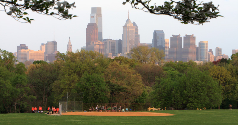 Baseball game at West Fairmont Park. In the background is the skyline of Phiadelphia