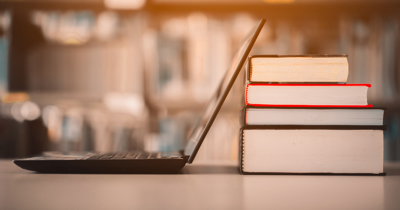 1177967778 Bookshelves and laptops are placed on the library desk.E-learning class and e-book digital technology