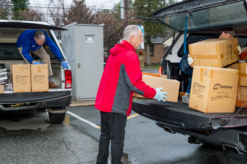 Michael (Mike) Gladle, Director of Environmental Health & Safety and Mark Seifert, Director, Emergency Management at UD’s Public Safety, gather PPE donations from around the campus to donate to Nikki Testa, from the Delaware Emergency Management Agency.