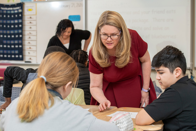 Brandy Cooper (blonde hair), College of Education & Human Development, has written a book with help from Professor Amanda Jansen who “wants to make math fun” at Milford Central Middle school, February 21, 2020.