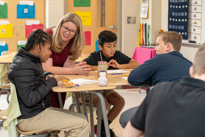 Brandy Cooper (blonde hair), College of Education & Human Development, has written a book with help from Professor Amanda Jansen who “wants to make math fun” at Milford Central Middle school, February 21, 2020.