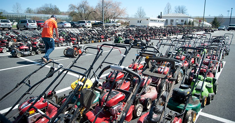Lawn mowers lined up behind UD's Townsend Hall