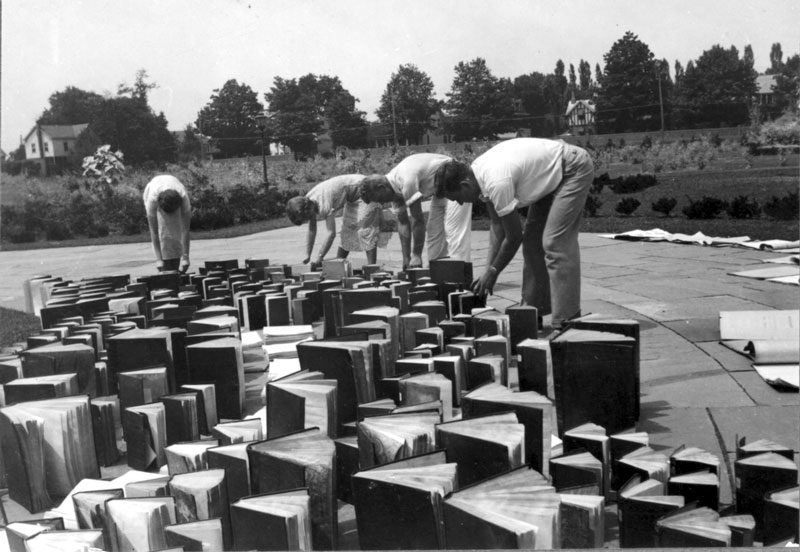 Students and staff cleaning up books after the flood of 1937