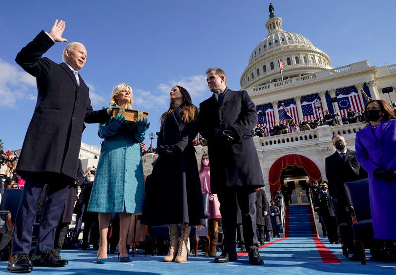 APTOPIX Biden Inauguration University of Delaware alumnus Joseph R. Biden, Jr. is sworn in as the 46th President of the United States by Chief Justice John Roberts as fellow UD graduate Jill Biden holds the Bible during the 59th Presidential Inauguration at the U.S. Capitol in Washington, on Wednesday, Jan. 20, 2021, as their children Ashley and Hunter watch. Vice President Kamala Harris (far right) was also sworn in on Jan. 20.
