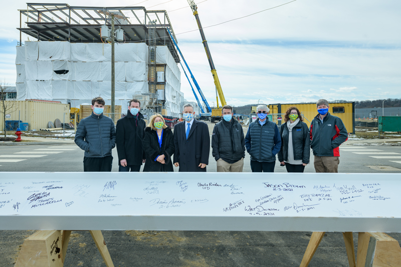 Beam signing ceremony for the ceremonial last beam to “top out” the FinTech building on UD’s STAR campus. Built by a partnership between UD, the Delaware Technology Park (DTP), and Discover Bank, the building will allow the partners to tap into the world of financial services technology (fintech).Pictured (from left): John Weber, Business and Economics class of ’23; Bruce Weber, Dean of the Alfred Lerner College of Business and Economics; Eleni Assanis; Dennis Assanis, President of the University of Delaware; Matt Parks, Vice President Investments, CRA, and Retail Banking with Discover Financial Services and ’02 University of Delaware MBA Alumni; Mike Bowman, Associate Director of the Office of Economic Innovation and Partnerships; Beth Brand, Vice President and University Secretary; Charlie Riordan, Vice President of Research, Scholarship, and Innovation and Professor of Chemistry and Biochemistry