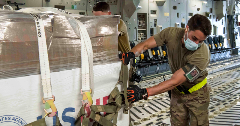 Staff Sgt. Salvatore Persico, 436th Aerial Port Squadron ramp shift supervisor, moves U.S. Agency for International Development ventilators to be delivered to Moscow, Russia, on a U.S. Air Force C-17 Globemaster III assigned to Joint Base Charleston, South Carolina, at Dover Air Force Base, Delaware, June 2, 2020. Dover AFB’s strategic location facilitates the expedient delivery of supplies throughout the globe, including Russia, where the COVID-19 outbreak is worsening and there are the third-highest number of cases in the world and the highest number of cases in Europe. (U.S. Air Force photo by Senior Airman Christopher Quail) (This image has been altered for security purposes)