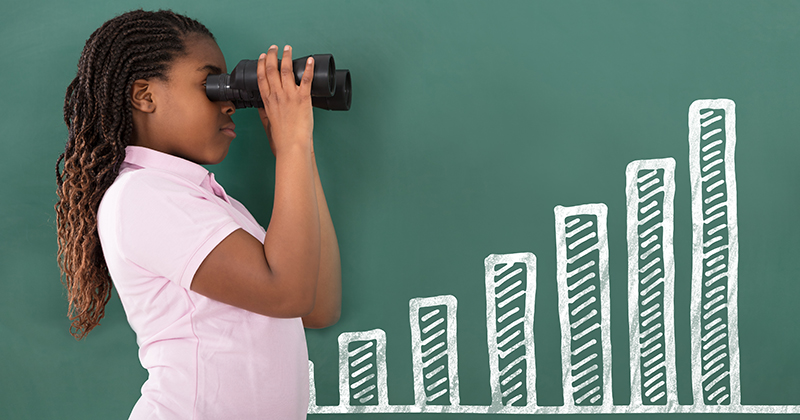 Student looks through binoculars at a graph.