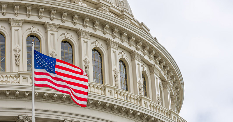 US Capitol building with waving American flag in Washington DC US Capitol building with waving American flag in Washington DC
