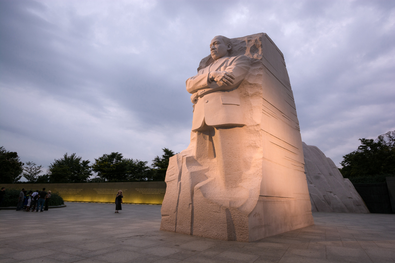476805554 Washington, United States - August 18, 2014: People meander about the Martin Luther King, Jr. Memorial in West Potomac Park, southwest of the National Mall, during the nighttime. The memorial honors civil rights leader Martin Luther King, Jr. (1929-1968) and was sculpted by Chinese sculptor Lei Yixin (born 1954).