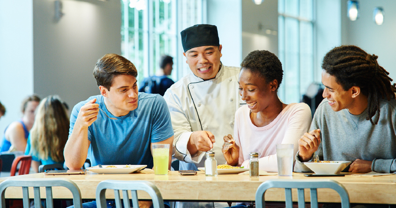 Web Aramark chef talking to three UD students