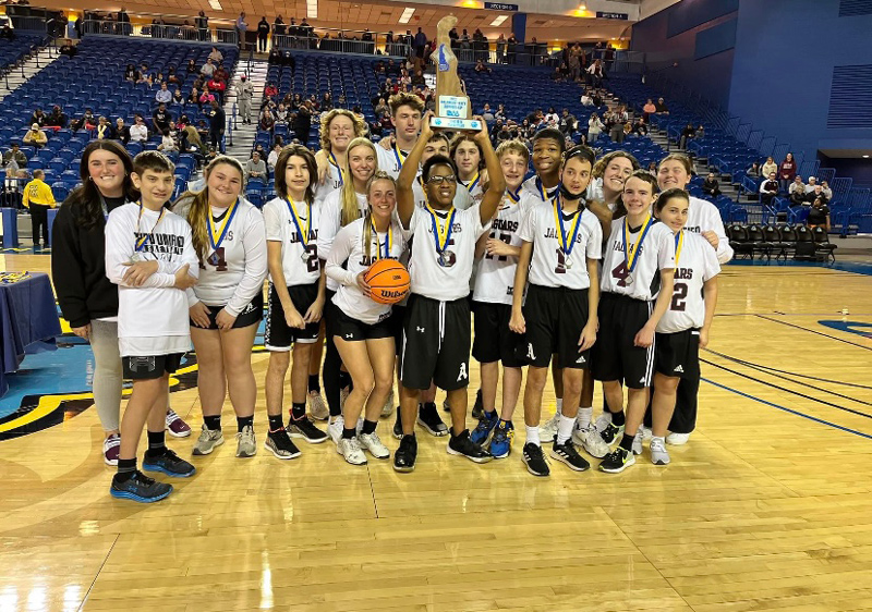 University of Delaware sophomore Autumn Gentry (far left), who coaches the Appoquinimink Unified Basketball team, poses with her team after it took home the runner-up trophy in the championship game on March 11, 2022.
