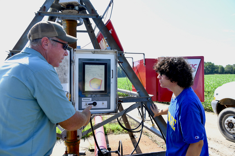 James Adkins, associate scientist and irrigation engineer, introduces Aaron Doll to the technology that drives precision agriculture at the UD Warrington Irrigation Research Farm in Harbeson. 