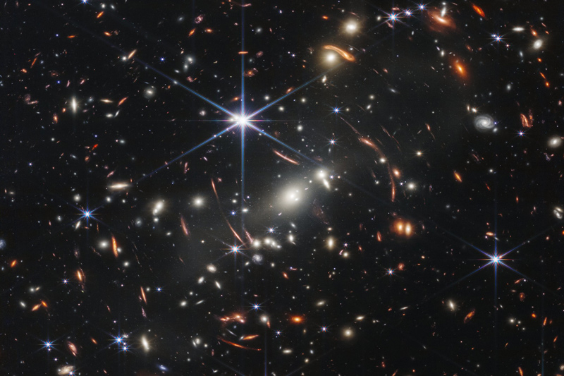 NASA’s James Webb Space Telescope has produced the deepest and sharpest infrared image of the distant universe to date. Known as Webb’s First Deep Field, this image of galaxy cluster SMACS 0723 is overflowing with detail. Thousands of galaxies — including the faintest objects ever observed in the infrared — have appeared in Webb’s view for the first time. This slice of the vast universe covers a patch of sky approximately the size of a grain of sand held at arm’s length by someone on the ground. NASA’s James Webb Space Telescope has produced the deepest and sharpest infrared image of the distant universe to date. Known as Webb’s First Deep Field, this image of galaxy cluster SMACS 0723 is overflowing with detail. Thousands of galaxies — including the faintest objects ever observed in the infrared — have appeared in Webb’s view for the first time. This slice of the vast universe covers a patch of sky approximately the size of a grain of sand held at arm’s length by someone on the ground.