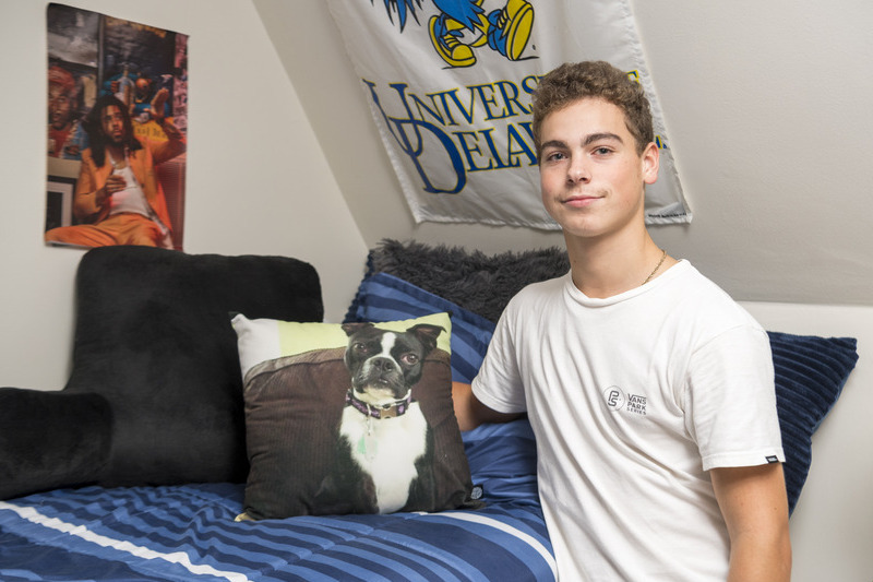 Adam Argo, a first-year student from Wilmington, Delaware, brings a pillow with a picture of his dog on it to the UD campus to make the campus feel a little more like home.