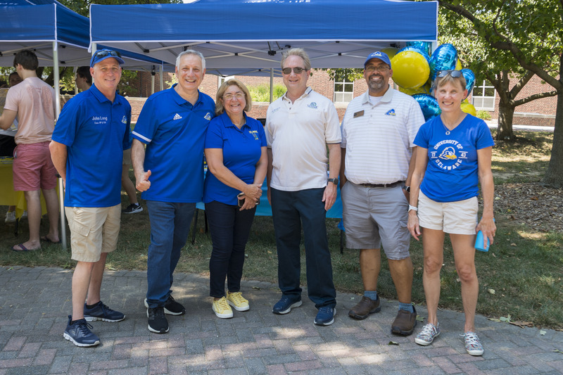 Welcoming new students and their families during move-in included, from left to right, Executive Vice President and Chief Operating Officer John Long, President Dennis Assanis, UD First Lady Eleni Assanis, Newark Mayor Stu Markham, Vice President for Student Life José-Luis Riera and Provost Laura Carlson.