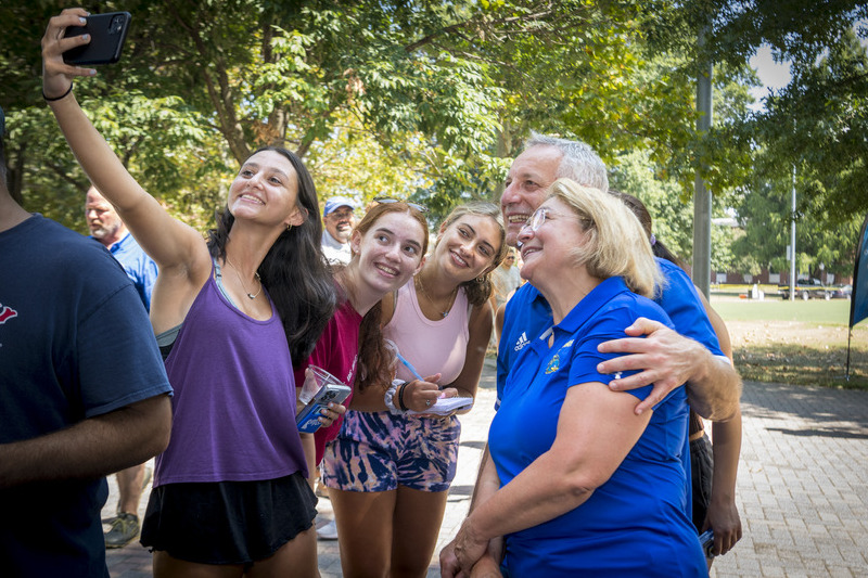 UD President Dennis Assanis and his wife, Eleni, greet students as they move into the residence halls.