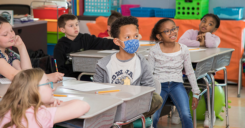 Third grade students from Wilbur Elementary School listen while a special guest reads a story about saving money to them. Third grade students from Wilbur Elementary School listen while a special guest reads a story about saving money to them.