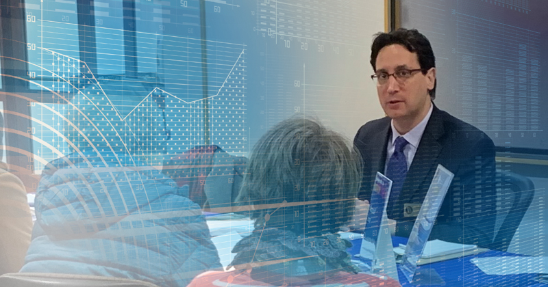 Excel instructor Mike Morris talking with prospective students