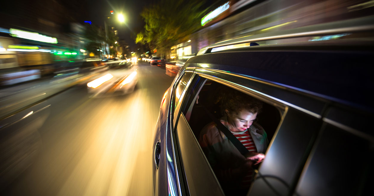Person riding in car and texting Rideshare safety