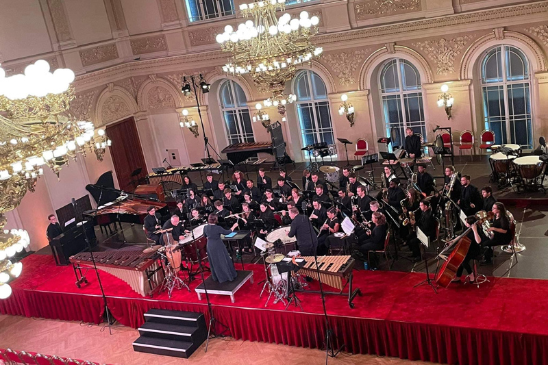 The UD Wind Ensemble performs for an international audience at the 2022 WASBE Conference, Great Hall at Žofín Palace.