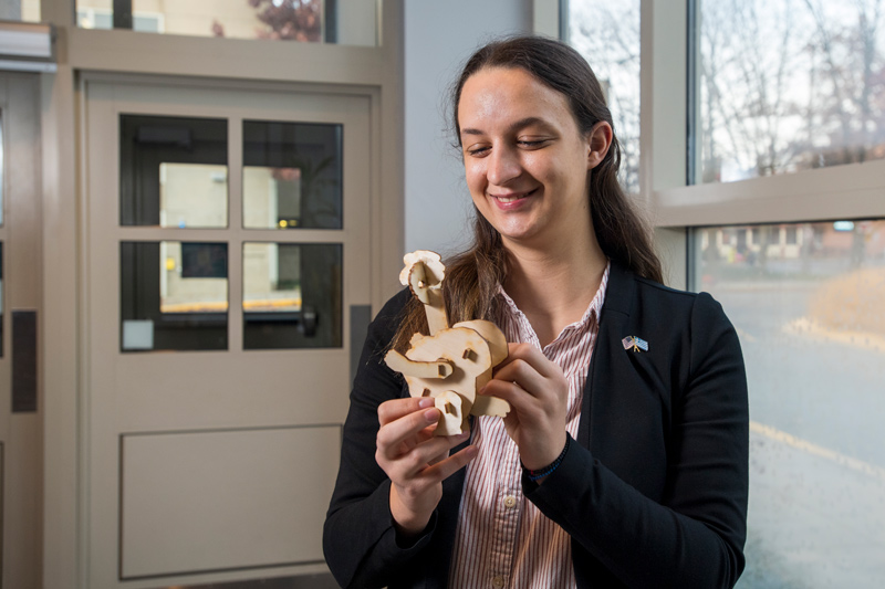 First-year Engineering student Geogia Angeletakis holds the birchwood model of the University’s YouDee mascot, complete with flapping wings. Beyond the mascot rah-rah, the task and requirements helped Angeletakis realize the value of people working effectively as a team to solve a problem.
