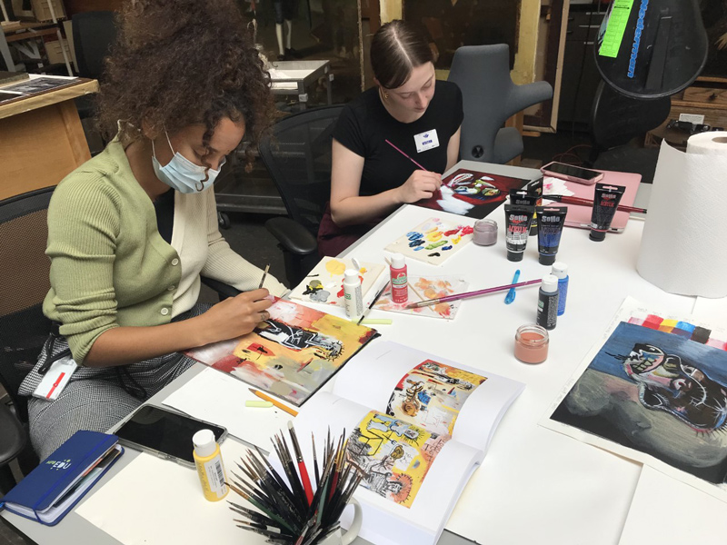 Student Amanei Johnson (left) and UD alumna Kelsey Marino work with the toolkits being made available to art teachers.