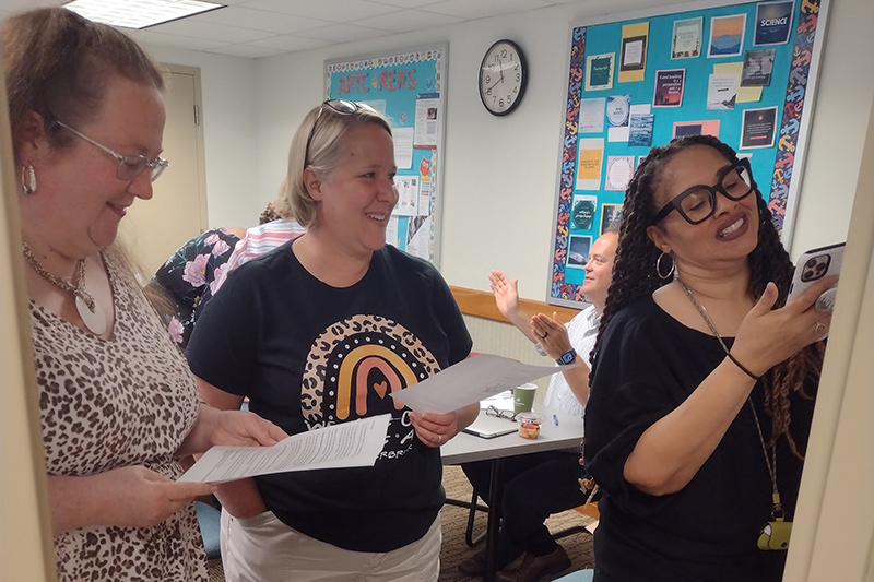 Sonya Sheppard (right) draws on flip chart paper as JoEllen Clark (left) and Amy Carlson (middle) provide suggestions as they work through one of the model lessons. Representing three different schools in Delaware, these teachers valued the opportunity to learn from each other during the summer institute. 