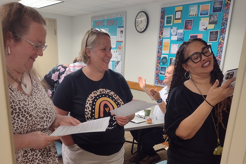 Sonya Sheppard (right) draws on flip chart paper as JoEllen Clark (left) and Amy Carlson (middle) provide suggestions as they work through one of the model lessons. Representing three different schools in Delaware, these teachers valued the opportunity to learn from each other during the summer institute. Sonya Sheppard (right) draws on flip chart paper as JoEllen Clark (left) and Amy Carlson (middle) provide suggestions as they work through one of the model lessons. Representing three different schools in Delaware, these teachers valued the opportunity to learn from each other during the summer institute.