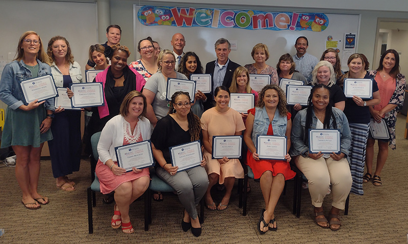 Fourth-grade educators pose with Gov. John Carney and Secretary of State Jefferey Bullock in celebration of completing the 2022 Democracy Project Summer Institute for Teachers. 