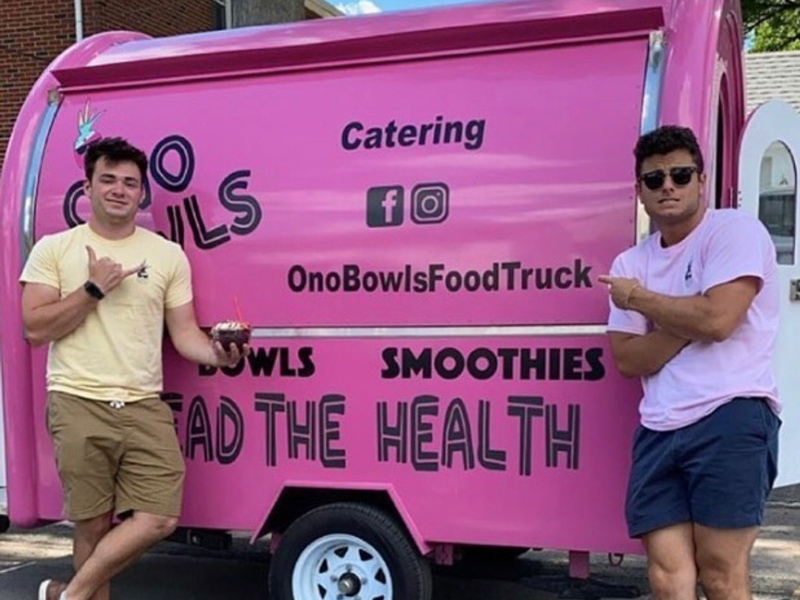 UD student Ben Quinutolo (left) and his business partner Chris Giuditta stand next to the original Ono Bowls Food Truck.