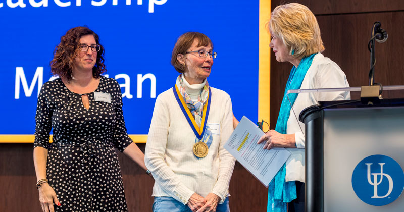 Debra Hess Norris and Beth Brand present Pam Cook with UD Medal of Distinction