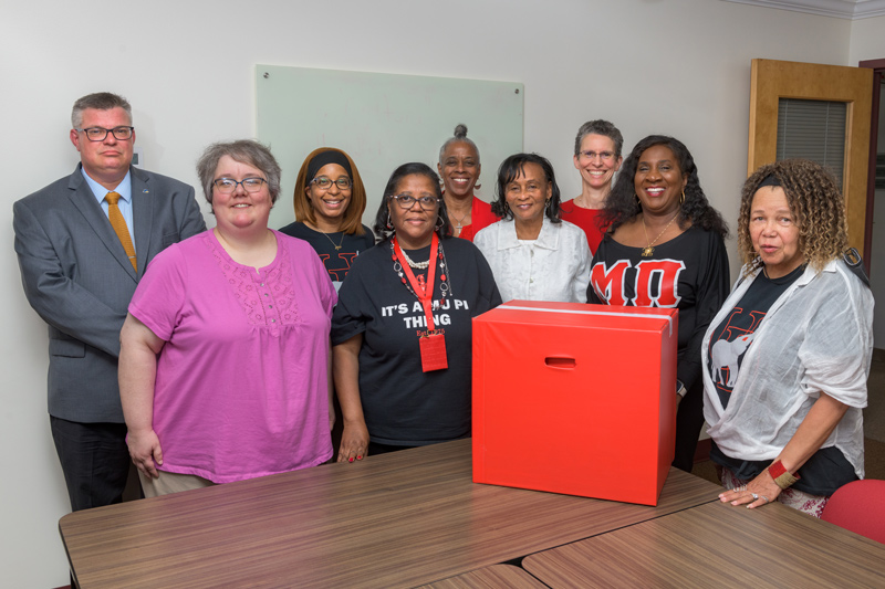 Gathering to mark the donation of memorabilia from the Mu Pi chapter of Delta Sigma Theta sorority were (from left to right) Director of University Archives and Records Management Ian Janssen, Coordinator of Archives Lisa Gensel, Jamett Garlick, Lethia Asare, Denise R. Hayman, Edith Moyer, Department of History Chair and Co-chair of the Anti-racism Initiative Alison Parker, Marlene Hurtt and Tara Williams.
