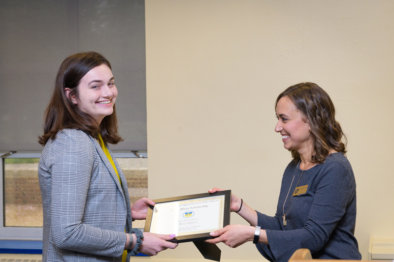 Olivia Ruggiero (left), a junior chemical engineering major, accepts the Kevin Miner Scholarship award from Lynda Dellmyer, assistant director of Disability Support Services (DSS). Ruggiero was diagnosed with cancer during her freshman year at UD and was able to return to campus three years later with support from DSS.